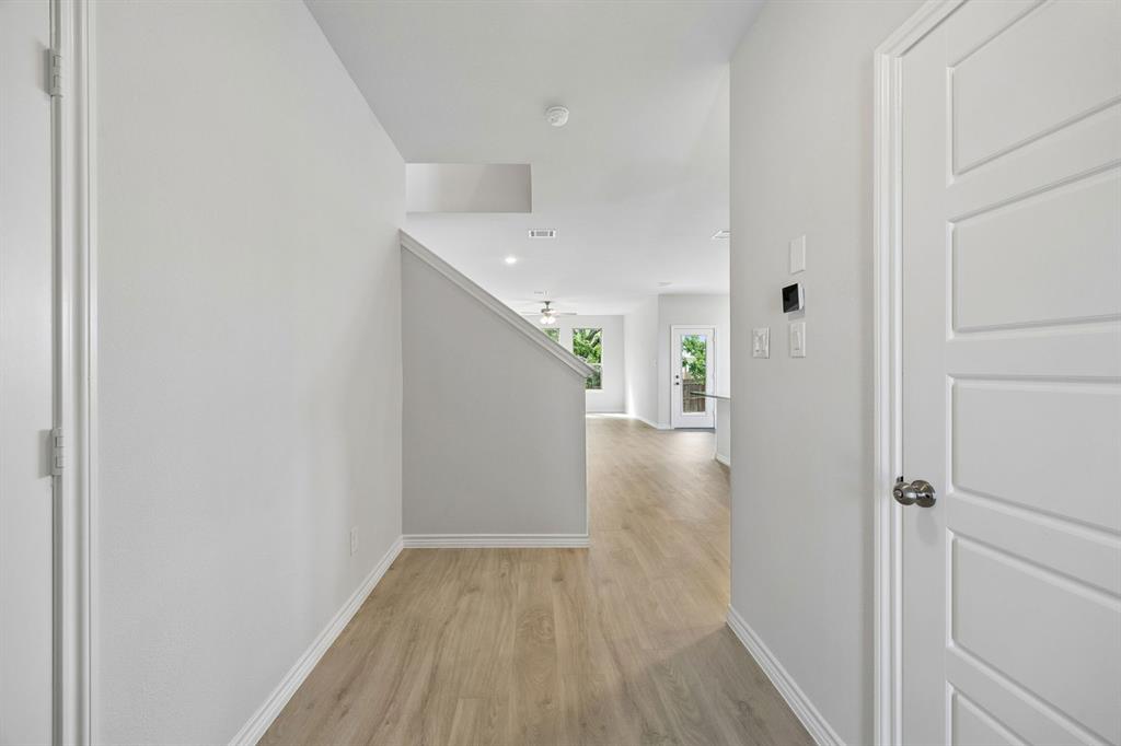 504-506 Mockingbird Lane Denton, TX 76209 - Photo 7 of 30 a view of a hallway with wooden floor