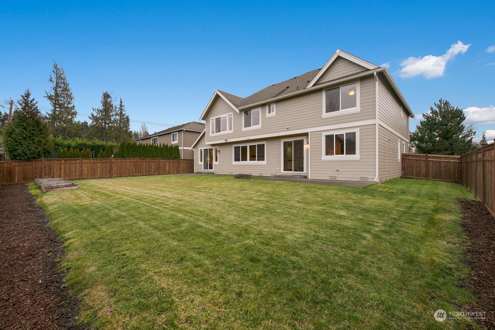 9912 Northeast 151st Street Bothell, WA 98011 - Photo 29 of 33 a view of a house with a yard and a garden