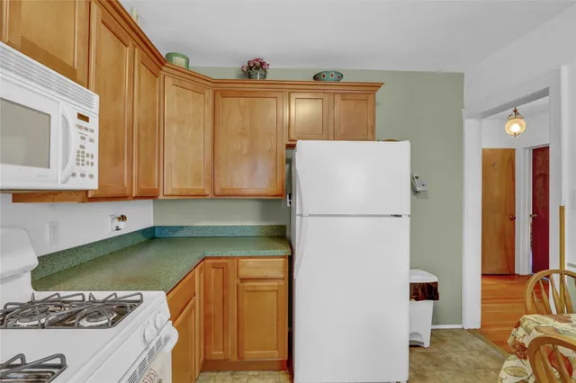 a kitchen with stainless steel appliances granite countertop a refrigerator and a stove