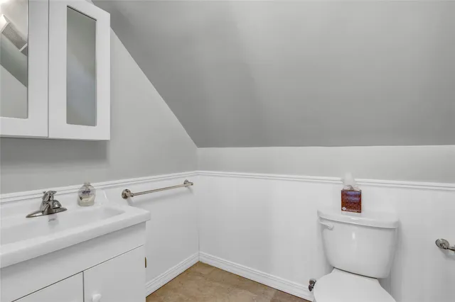 a bathroom with a sink a toilet and vanity