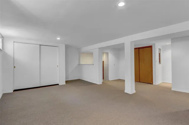 a view of an empty room with closet area
