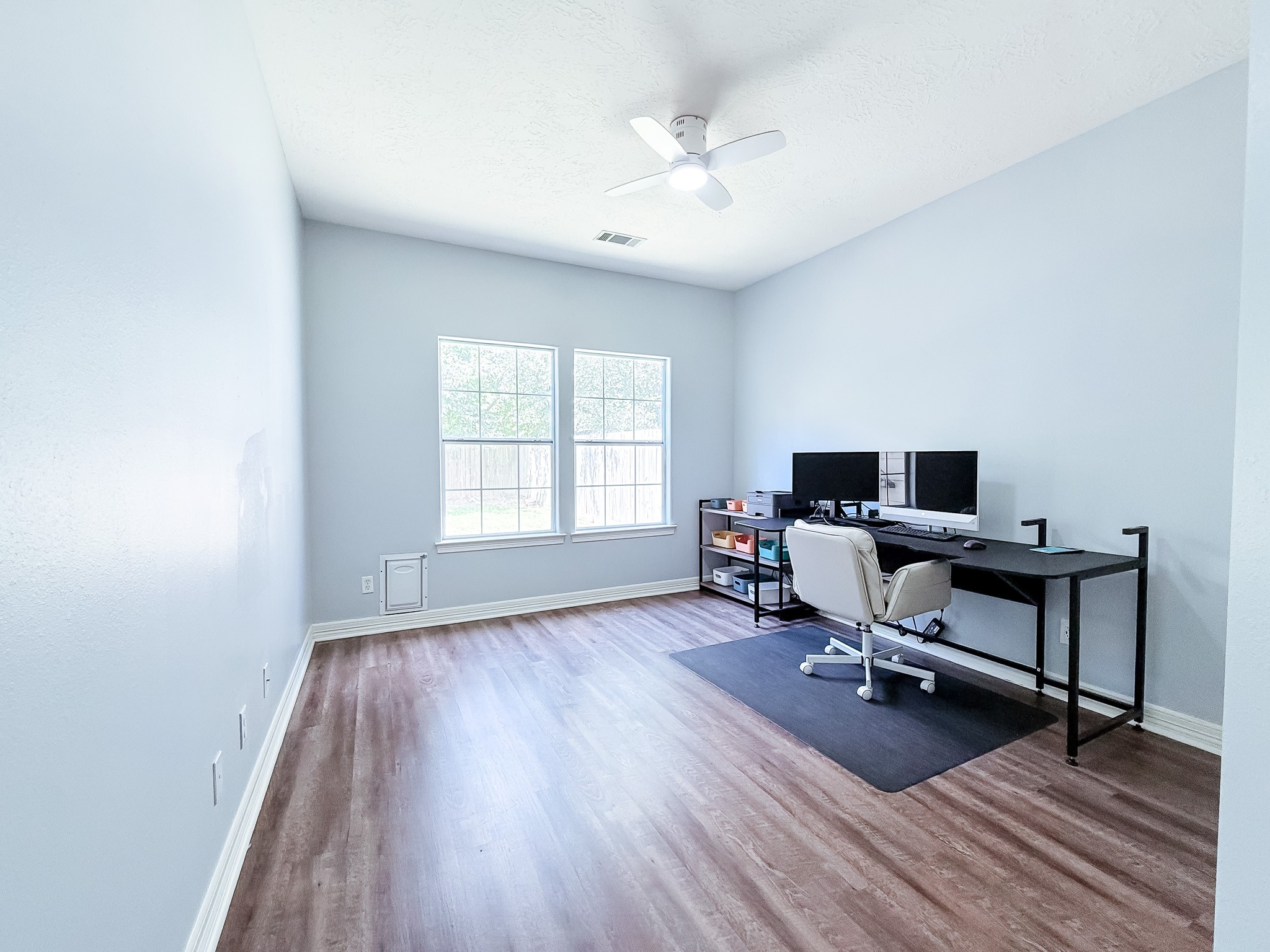 540 Springwood Drive Conroe, TX 77385 - Photo 17 of 23 Secondary bedrooms both feature updated & durable flooring, and a breezy ceiling fan!