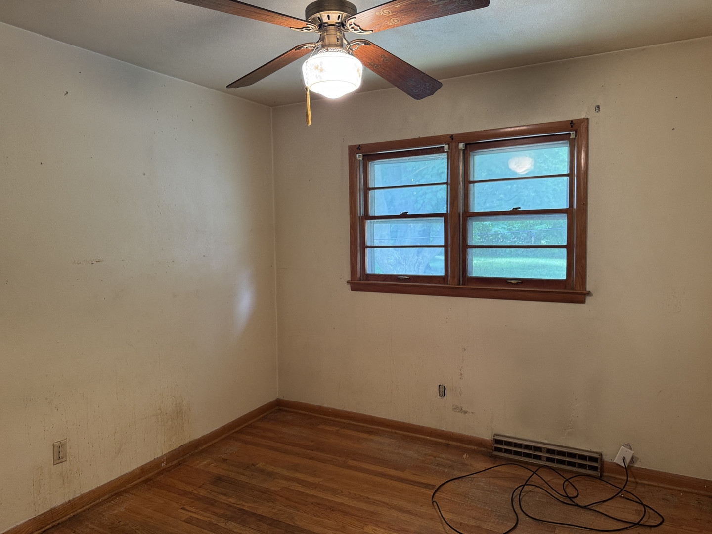 2024 Montague Road Rockford, IL 61102 - Photo 13 of 34 an empty room with wooden floor fan and windows