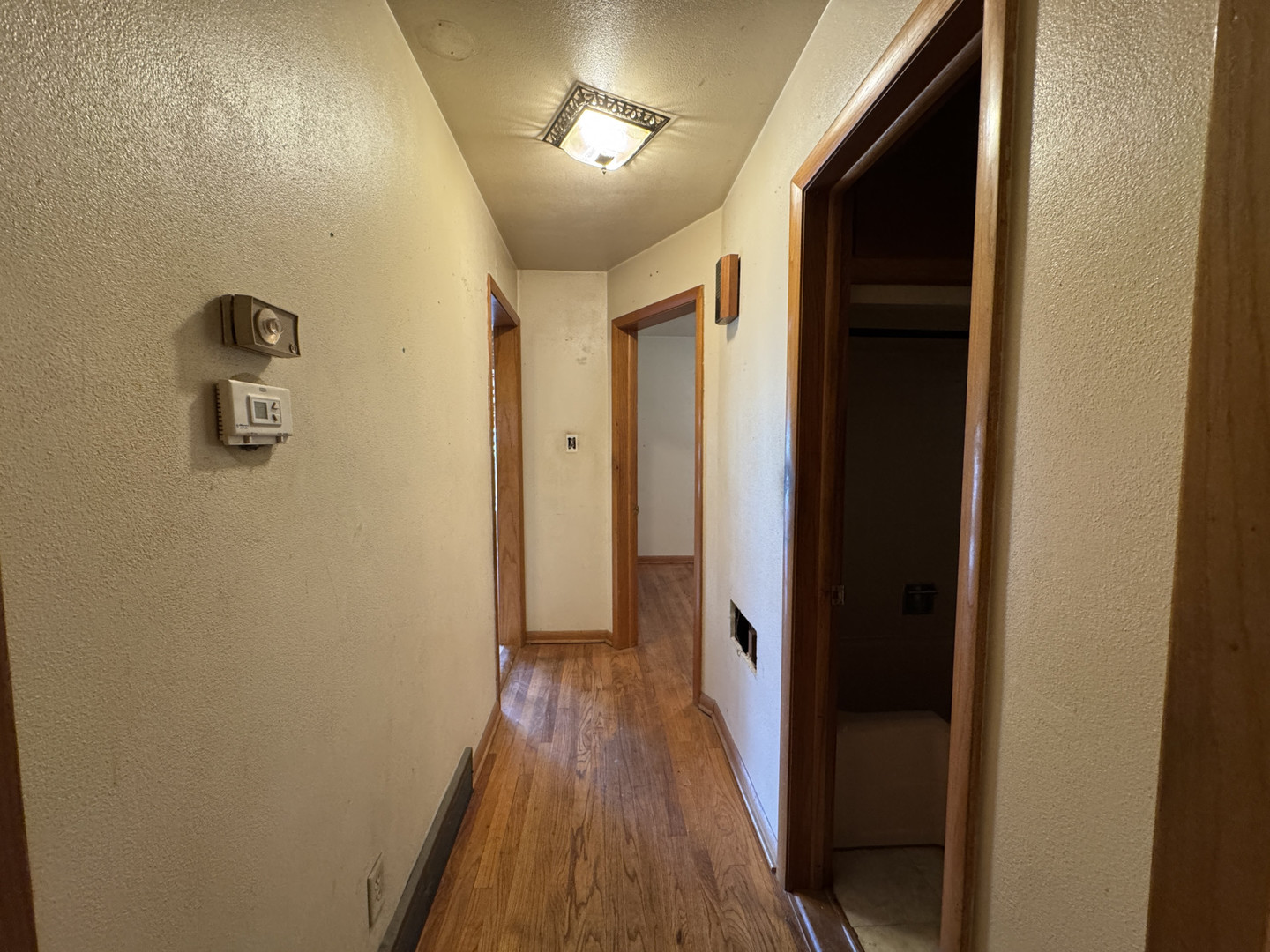 2024 Montague Road Rockford, IL 61102 - Photo 14 of 34 a view of a hallway with wooden floor and a bathroom