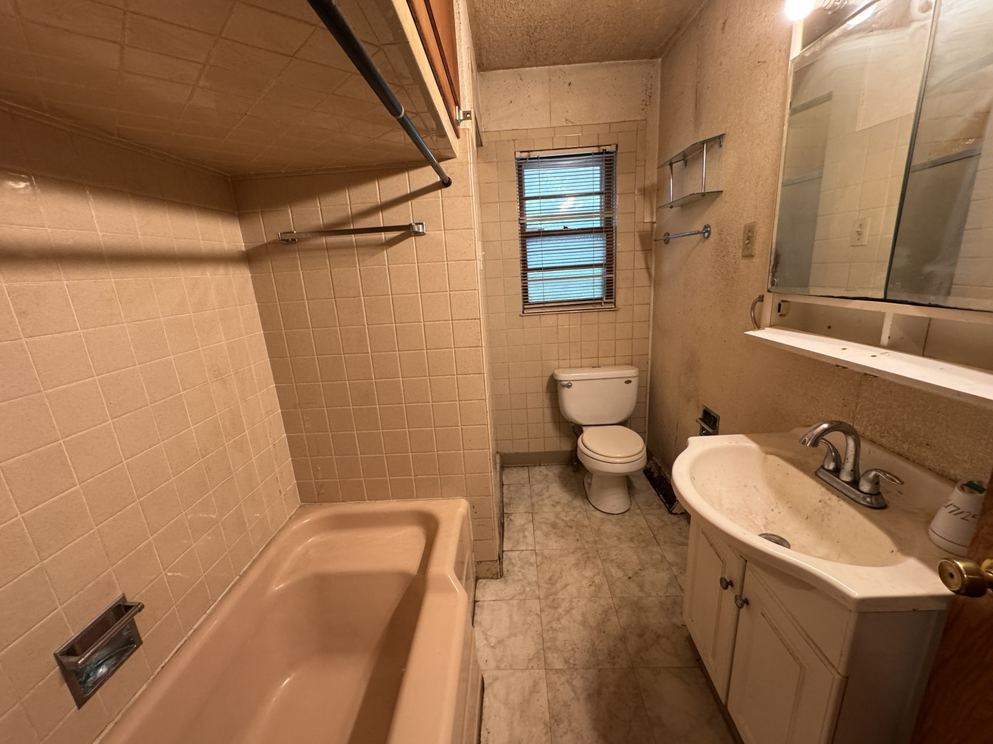 2024 Montague Road Rockford, IL 61102 - Photo 15 of 34 a bathroom with a sink a toilet a mirror and shower