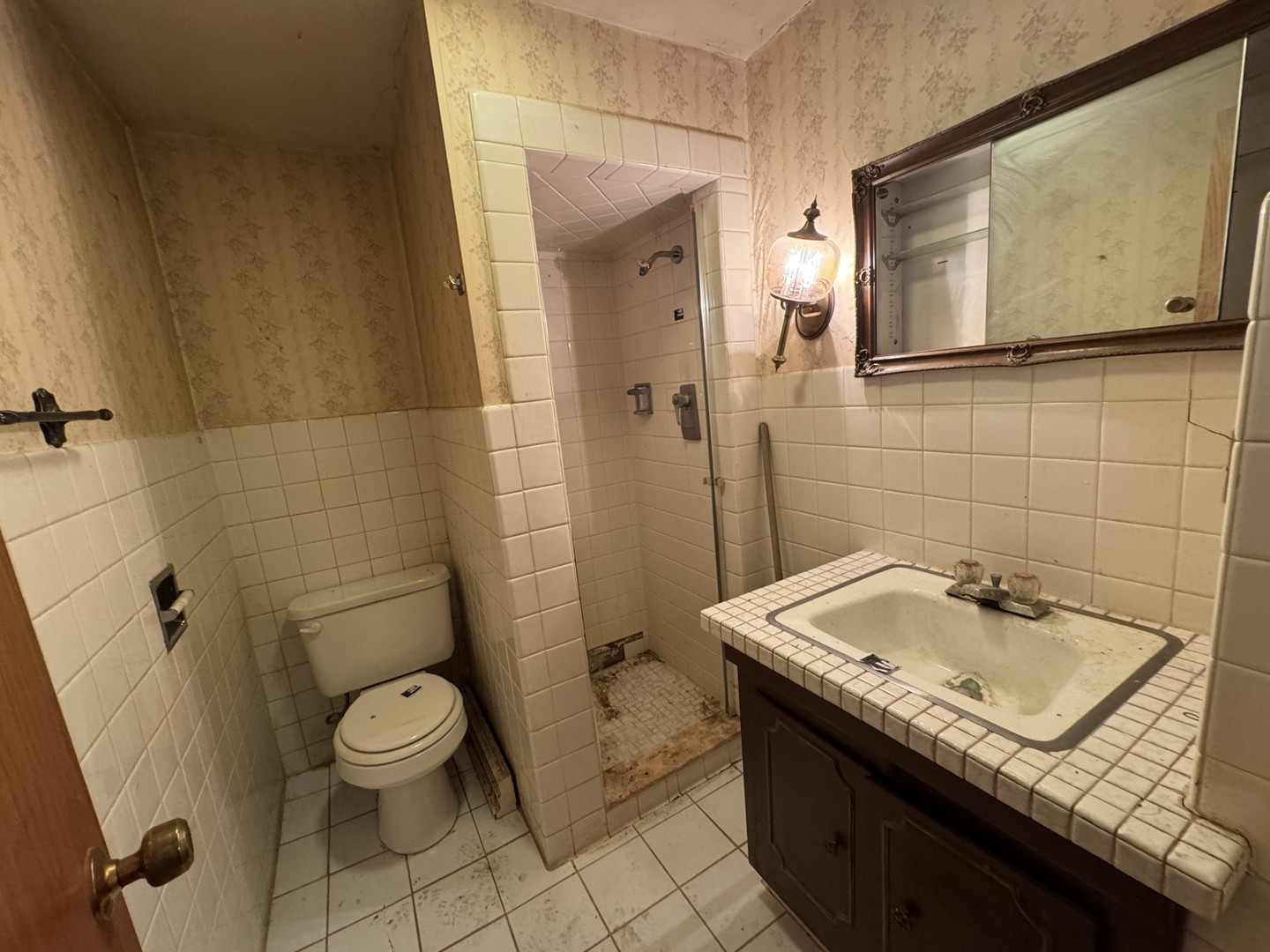 2024 Montague Road Rockford, IL 61102 - Photo 17 of 34 a bathroom with a sink a toilet and shower