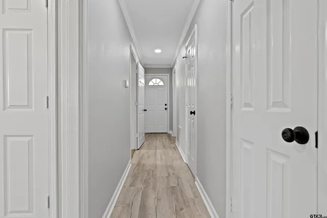 a view of a hallway with wooden floor