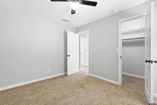 an empty room with a empty space and windows