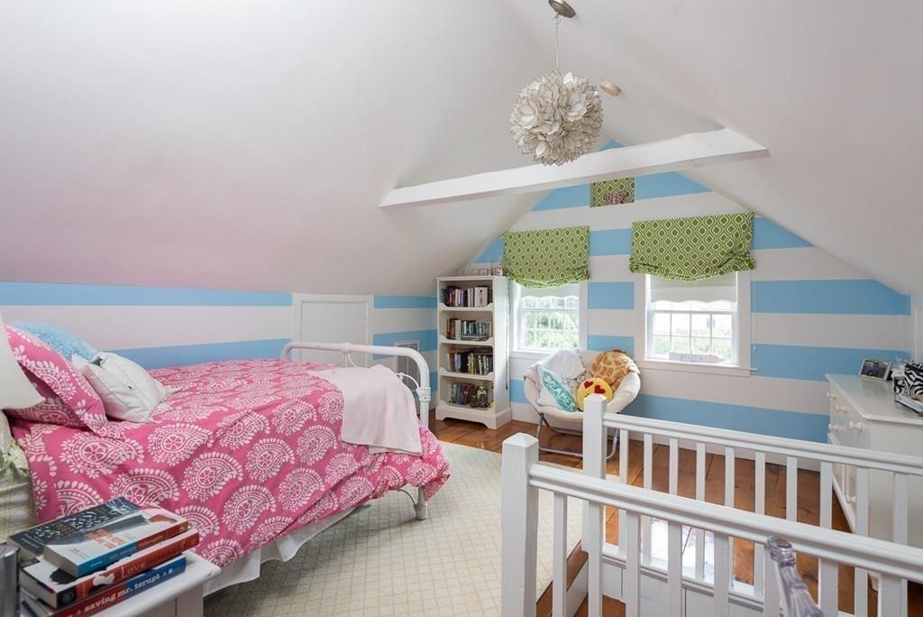 44 Middle Street Hingham, MA 02043 - Photo 17 of 23 a bedroom with furniture and a chandelier