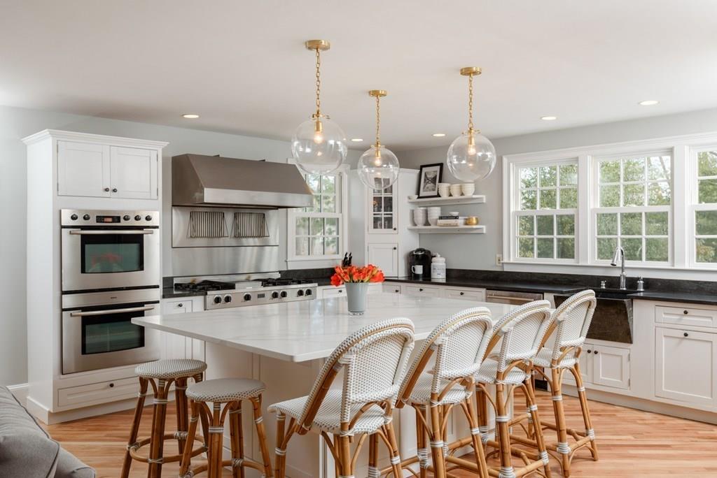 44 Middle Street Hingham, MA 02043 - Photo 4 of 23 a kitchen with kitchen island granite countertop a table and chairs in it