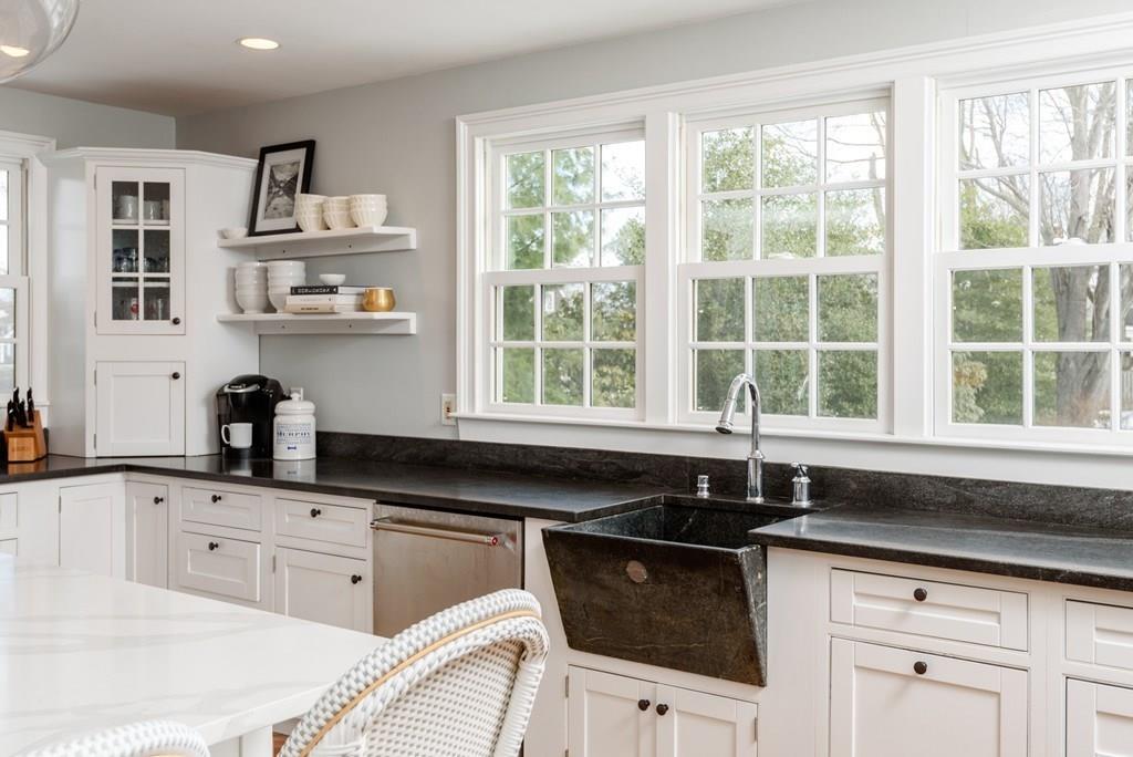 44 Middle Street Hingham, MA 02043 - Photo 5 of 23 a kitchen with granite countertop a sink white cabinets and a large window