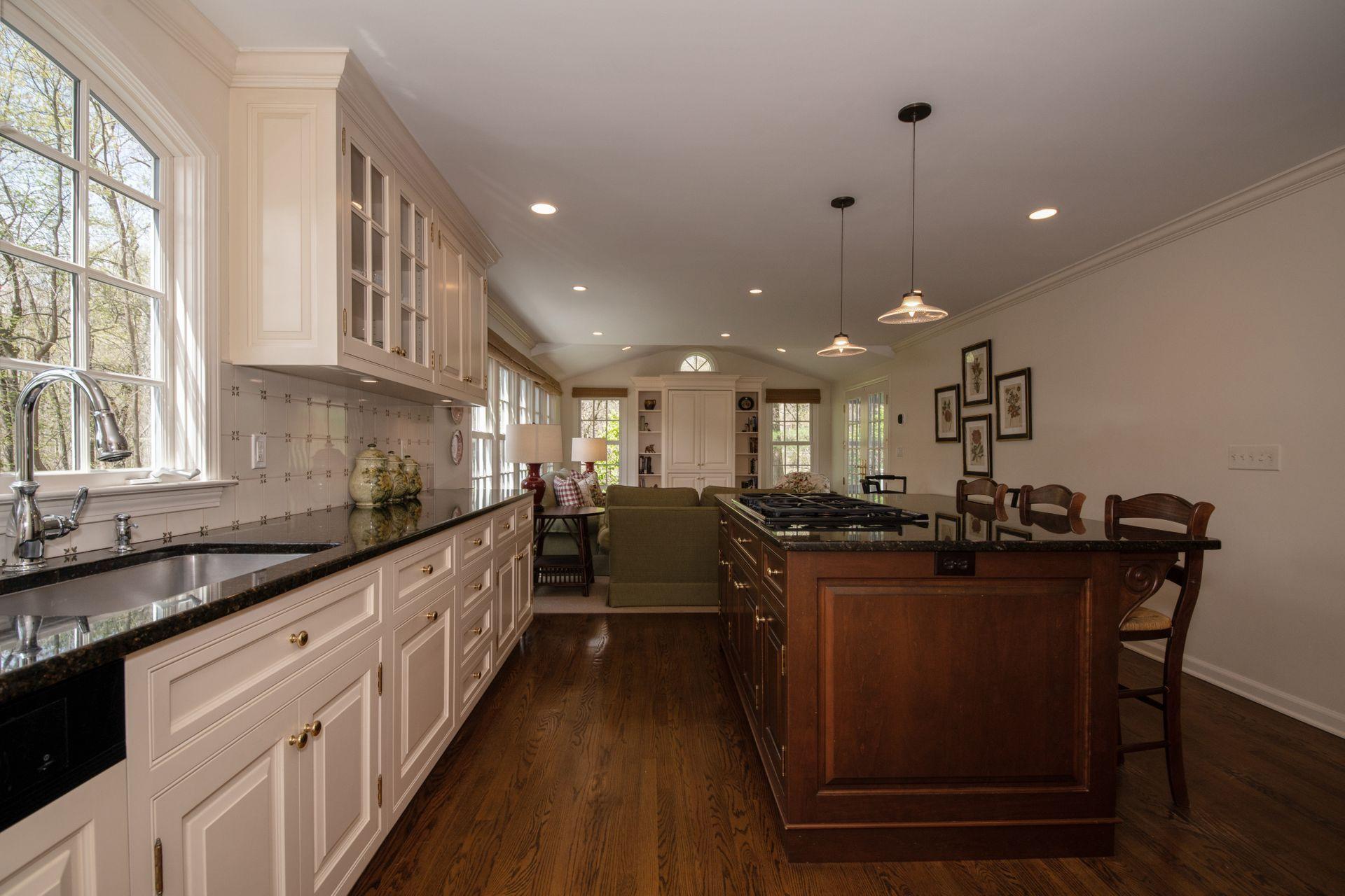 20 Colony Road Darien, CT 06820 - Photo 14 of 34 a kitchen with stainless steel appliances granite countertop sink stove and wooden floor