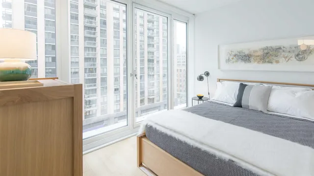 a spacious bedroom with a bed and a window