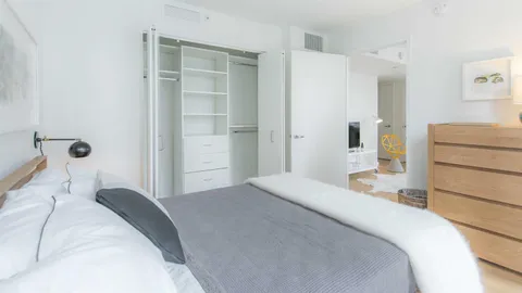 a bedroom with a bed and a cabinets