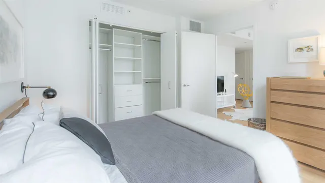 a bedroom with a bed and a cabinets