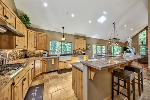 a spacious bedroom with a bed a fireplace with the outer view