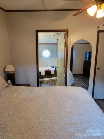 a bedroom with a bed and a mirror