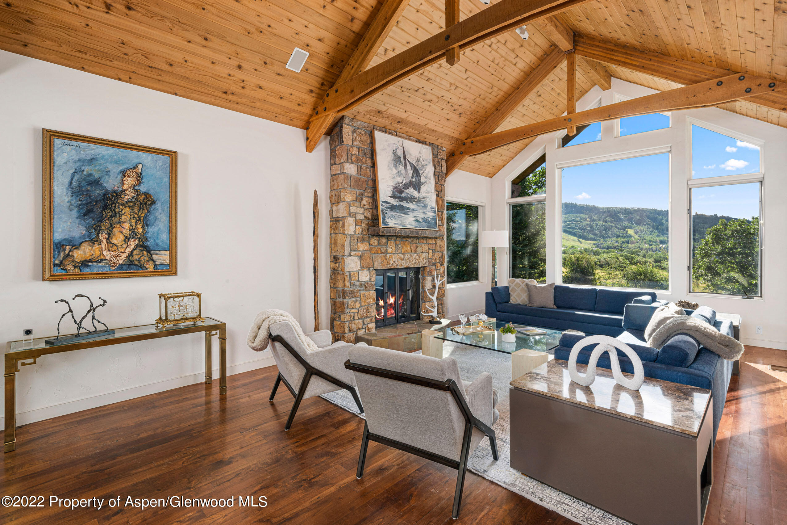 61 Primrose Path Aspen, CO 81611 - Photo 14 of 48 a living room with fireplace furniture and a large window