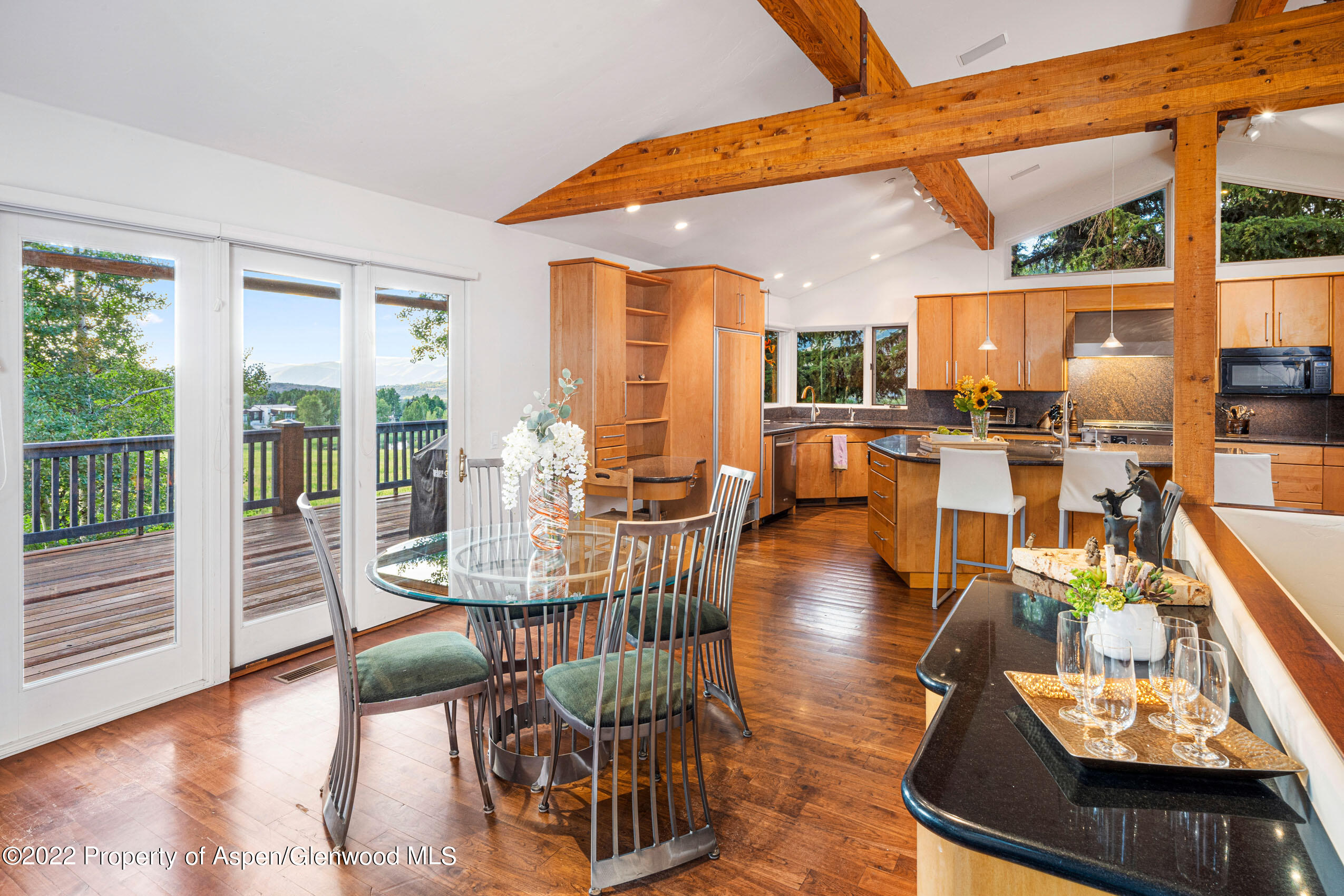 61 Primrose Path Aspen, CO 81611 - Photo 15 of 48 a view of a dining room with furniture wooden floor and a potted plant