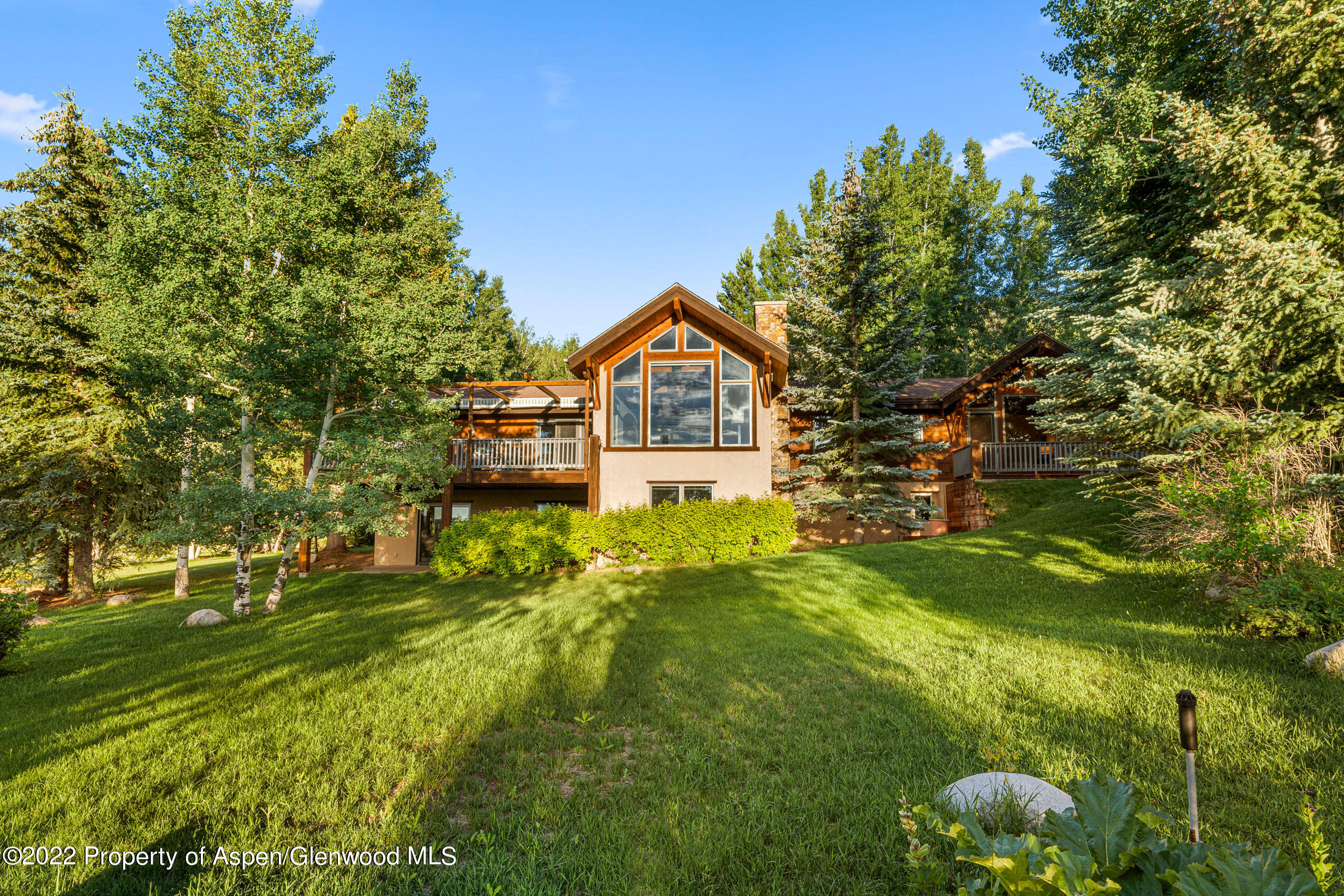 61 Primrose Path Aspen, CO 81611 - Photo 16 of 48 a view of a big yard with large trees and plants