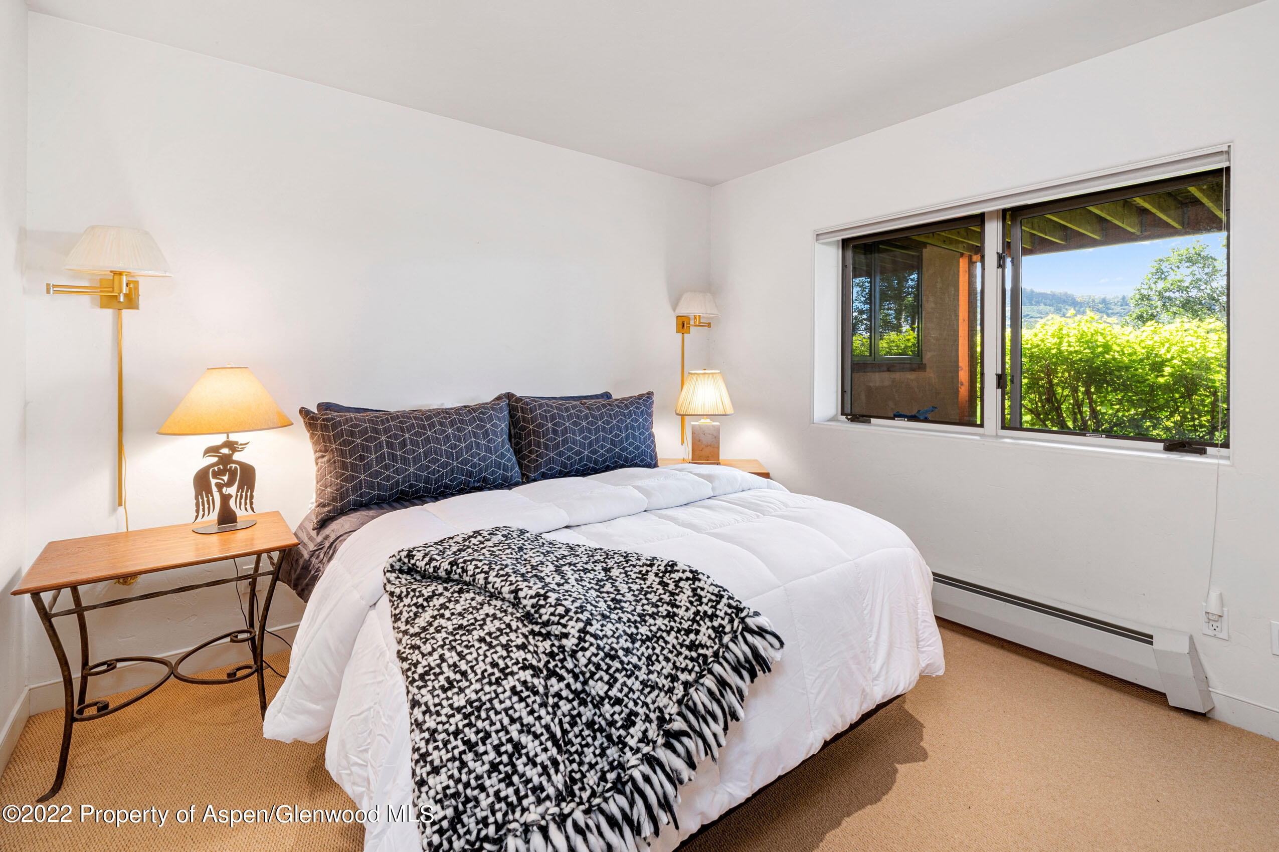 61 Primrose Path Aspen, CO 81611 - Photo 26 of 48 a bedroom with a bed and window
