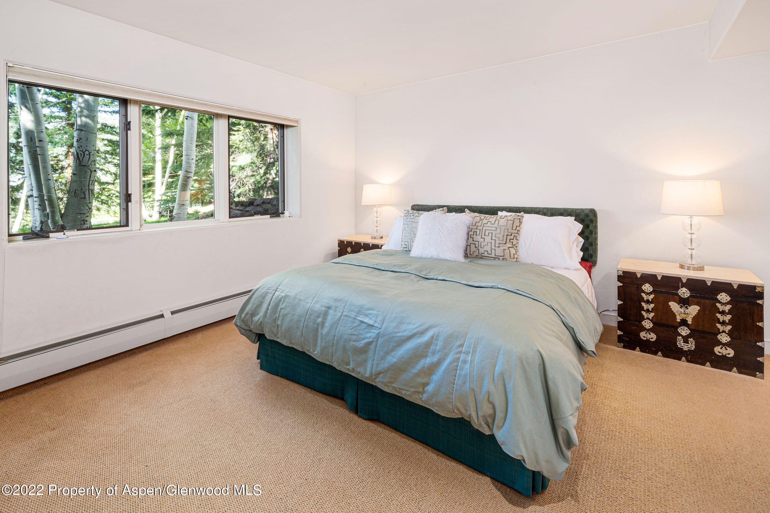 61 Primrose Path Aspen, CO 81611 - Photo 27 of 48 a bed sitting in a bedroom next to a window