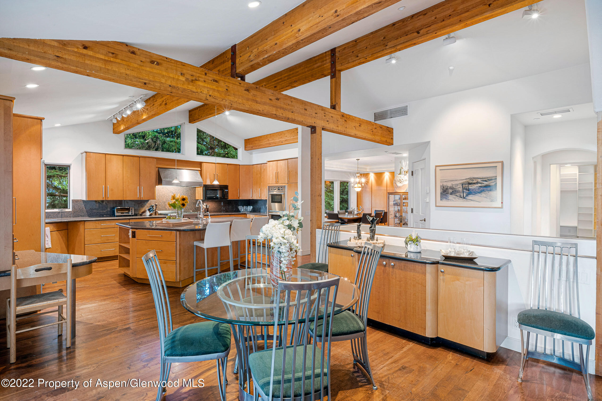 61 Primrose Path Aspen, CO 81611 - Photo 29 of 48 a kitchen with stainless steel appliances granite countertop table chairs and a large window