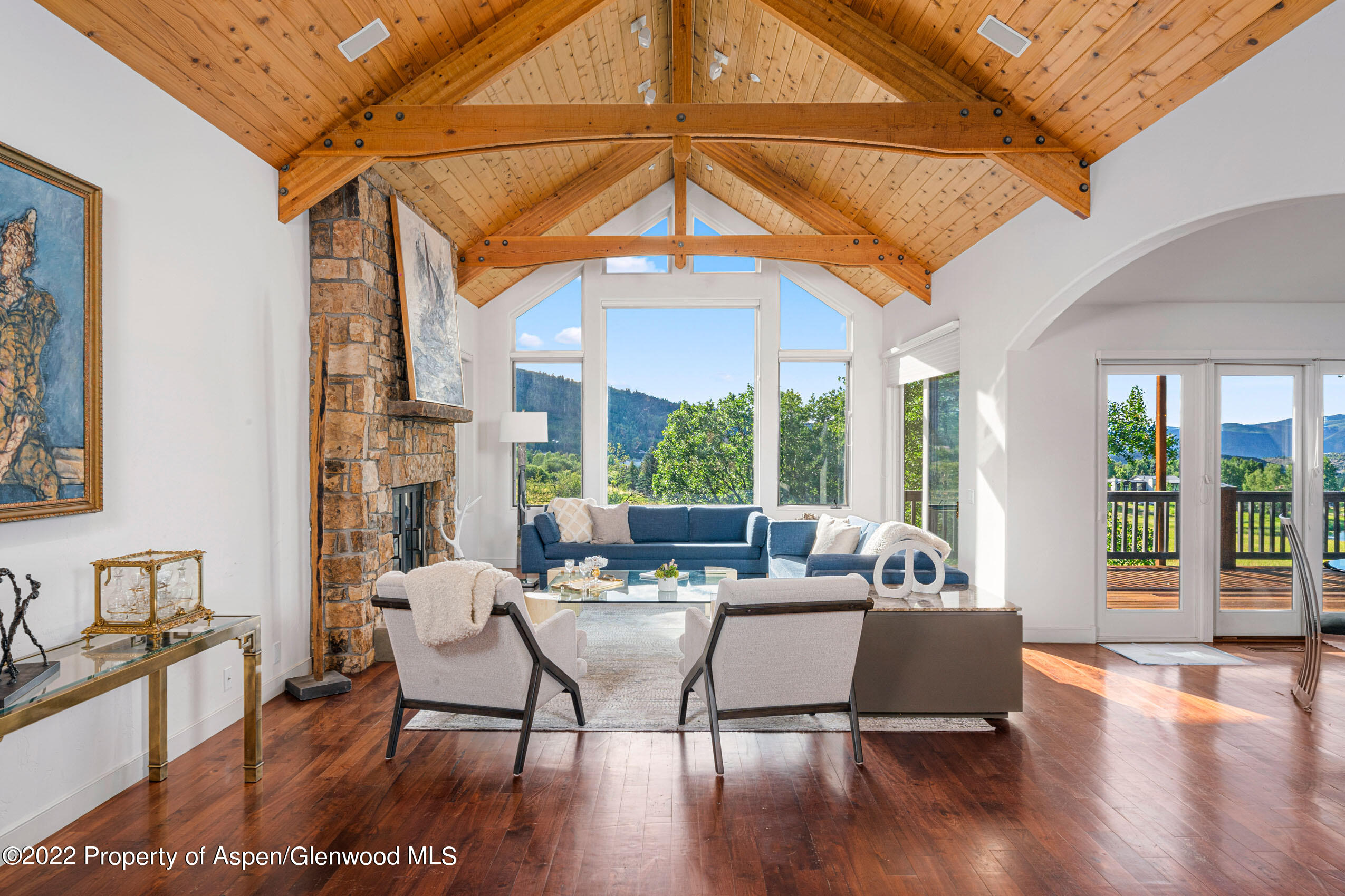 61 Primrose Path Aspen, CO 81611 - Photo 3 of 48 a living room with furniture a fireplace and a large window