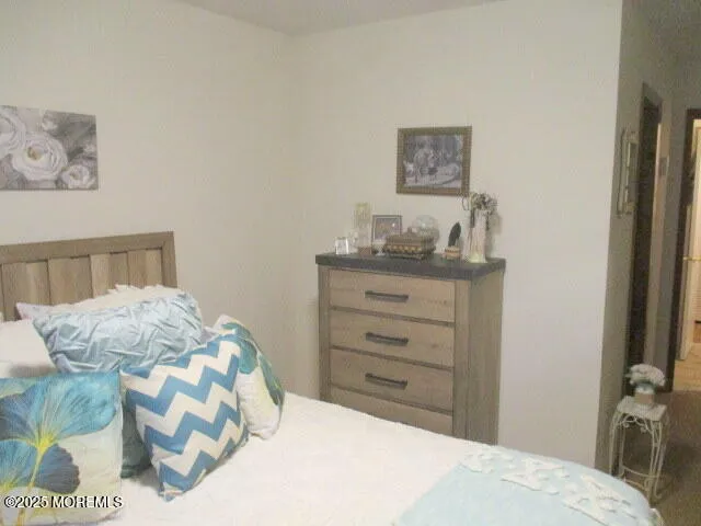 a bedroom with a bed and a dresser in it