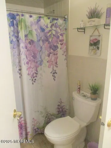 a white toilet sitting next to a bathroom sink