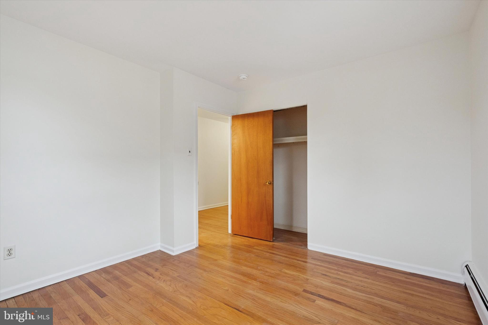230 South Carol Boulevard, Unit B000 Upper Darby, PA 19082 - Photo 12 of 25 a view of an empty room with wooden floor and a window