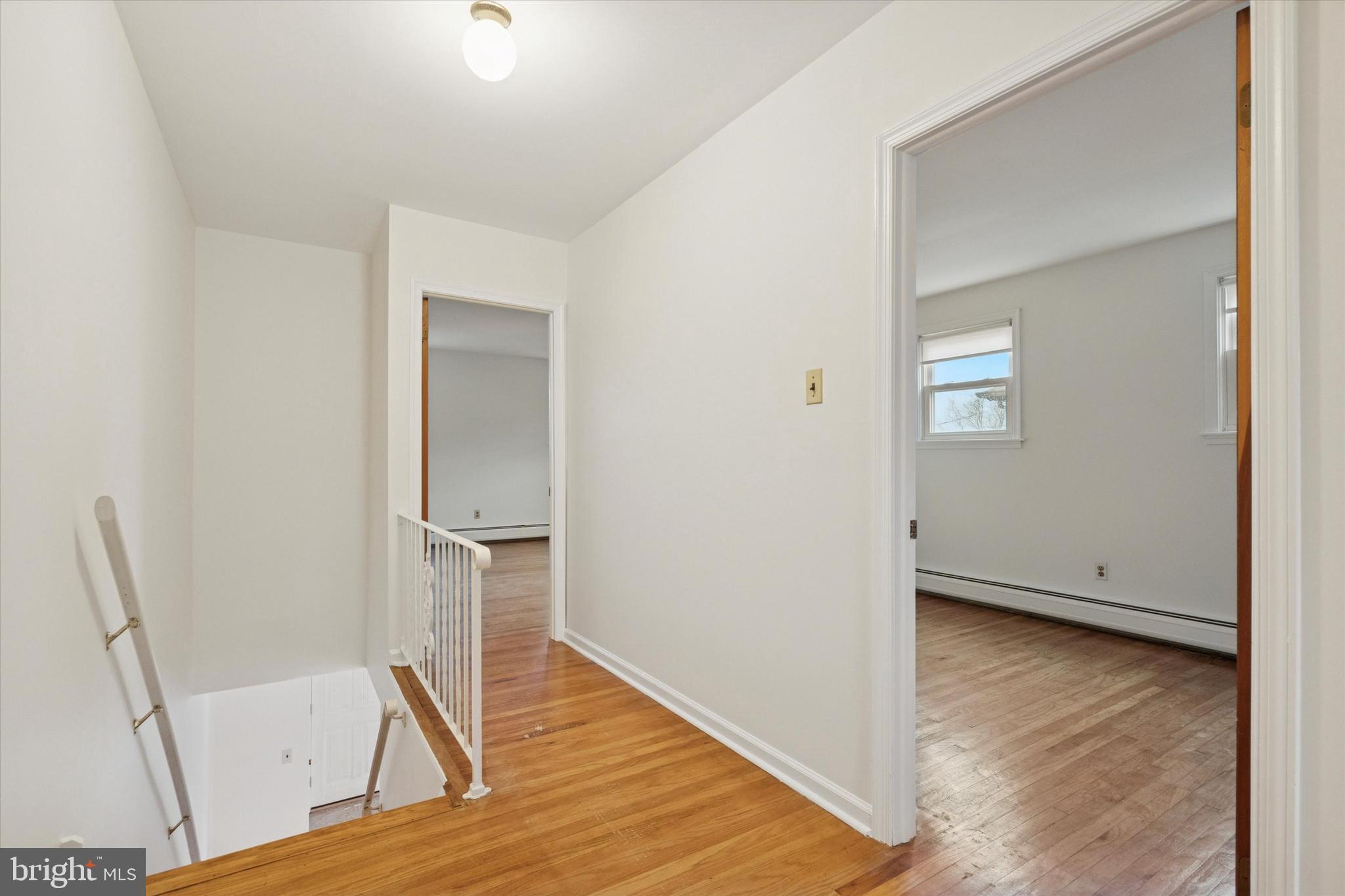 230 South Carol Boulevard, Unit B000 Upper Darby, PA 19082 - Photo 14 of 25 a view of empty room with wooden floor and chair