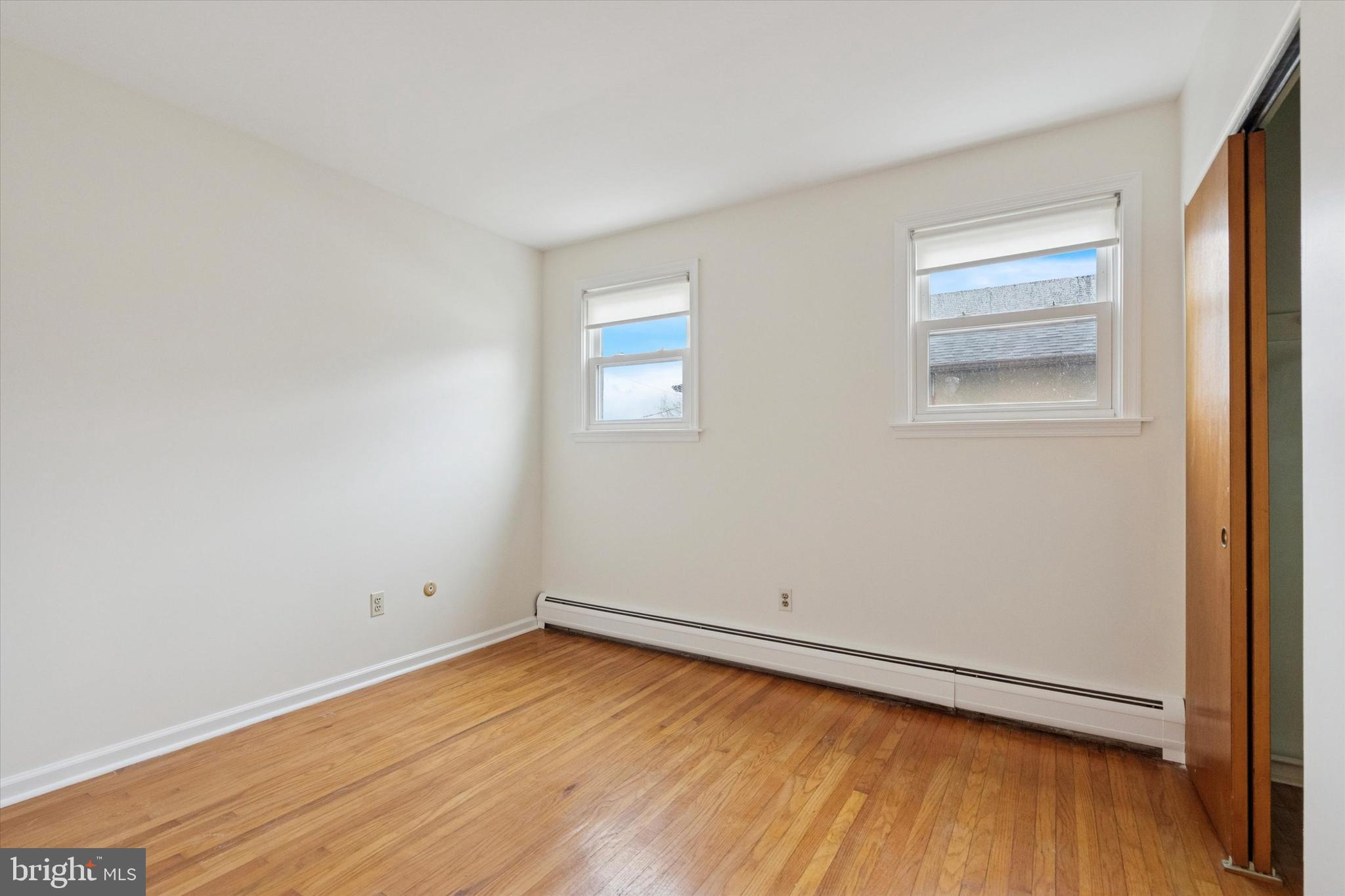 230 South Carol Boulevard, Unit B000 Upper Darby, PA 19082 - Photo 15 of 25 an empty room with wooden floor and windows