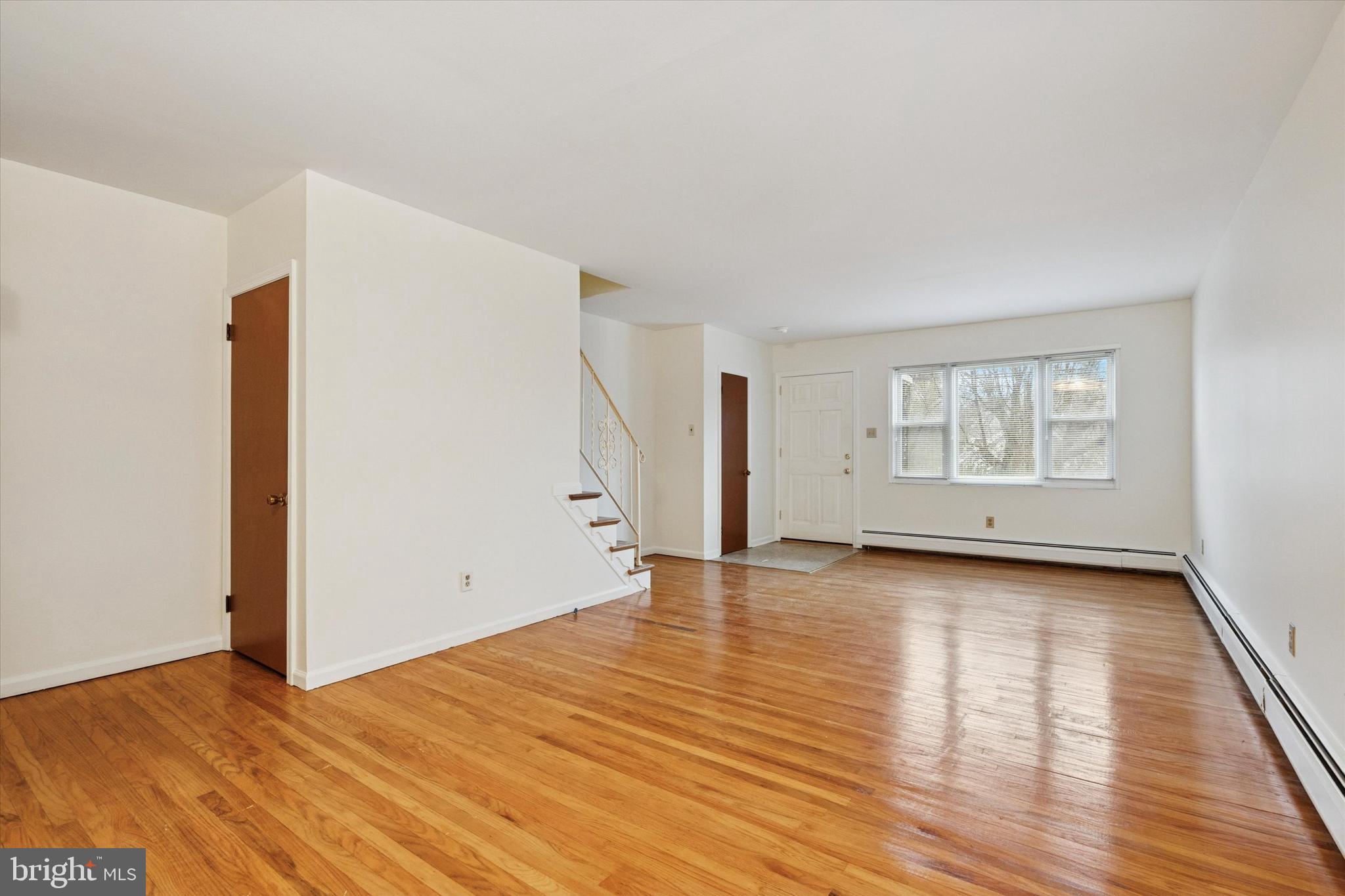 230 South Carol Boulevard, Unit B000 Upper Darby, PA 19082 - Photo 5 of 25 a view of an empty room with wooden floor and a window