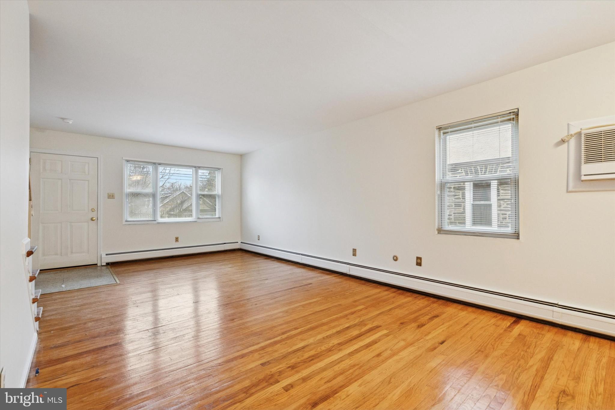 230 South Carol Boulevard, Unit B000 Upper Darby, PA 19082 - Photo 6 of 25 a view of an empty room with wooden floor and a window