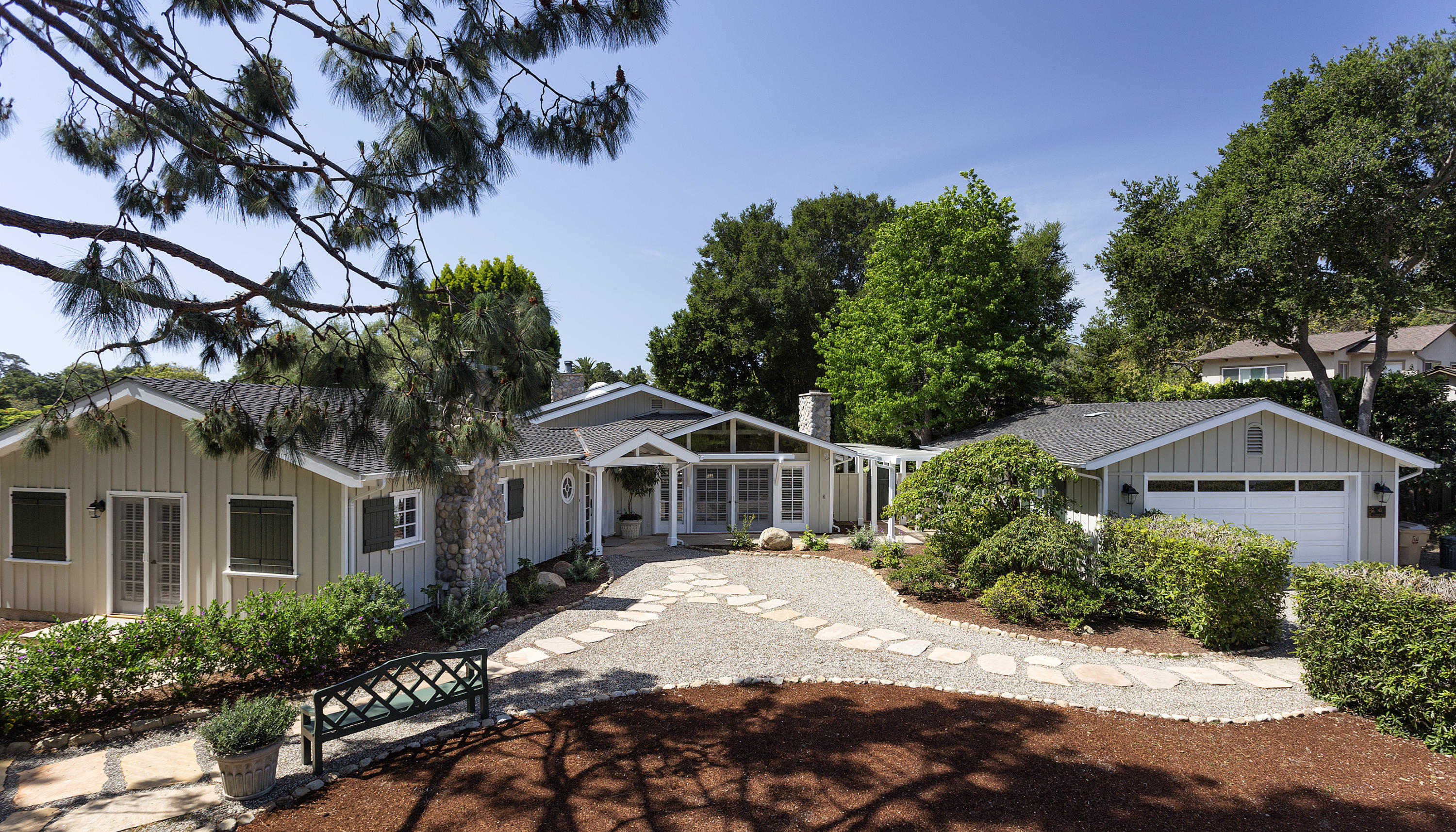 145 La Vereda Road Montecito, CA 93108 - Photo 1 of 17 a view of a white house with a large tree next to a yard