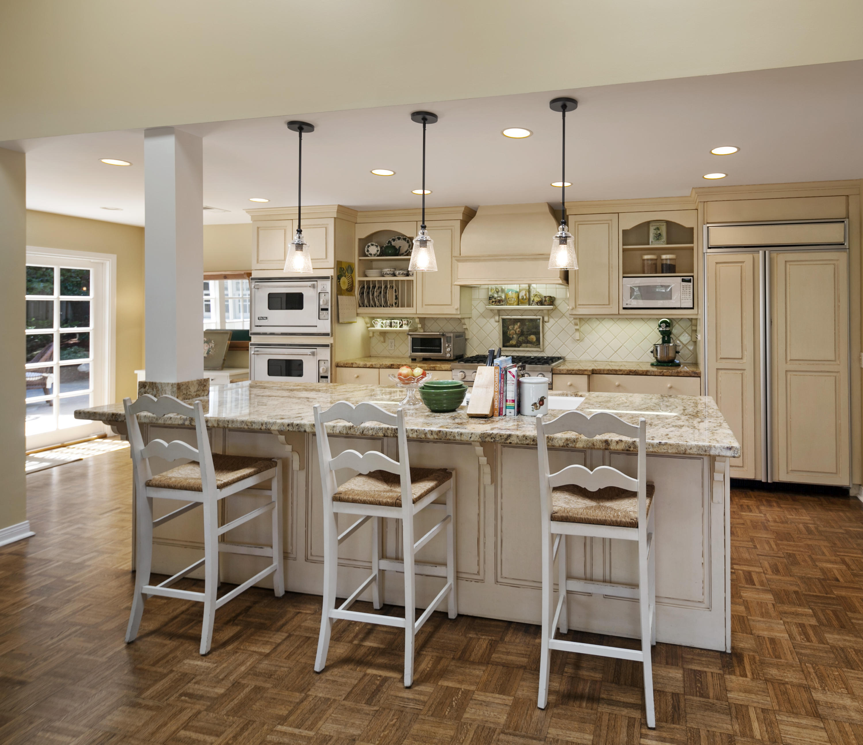 145 La Vereda Road Montecito, CA 93108 - Photo 8 of 17 a kitchen with stainless steel appliances kitchen island granite countertop a table chairs sink and cabinets