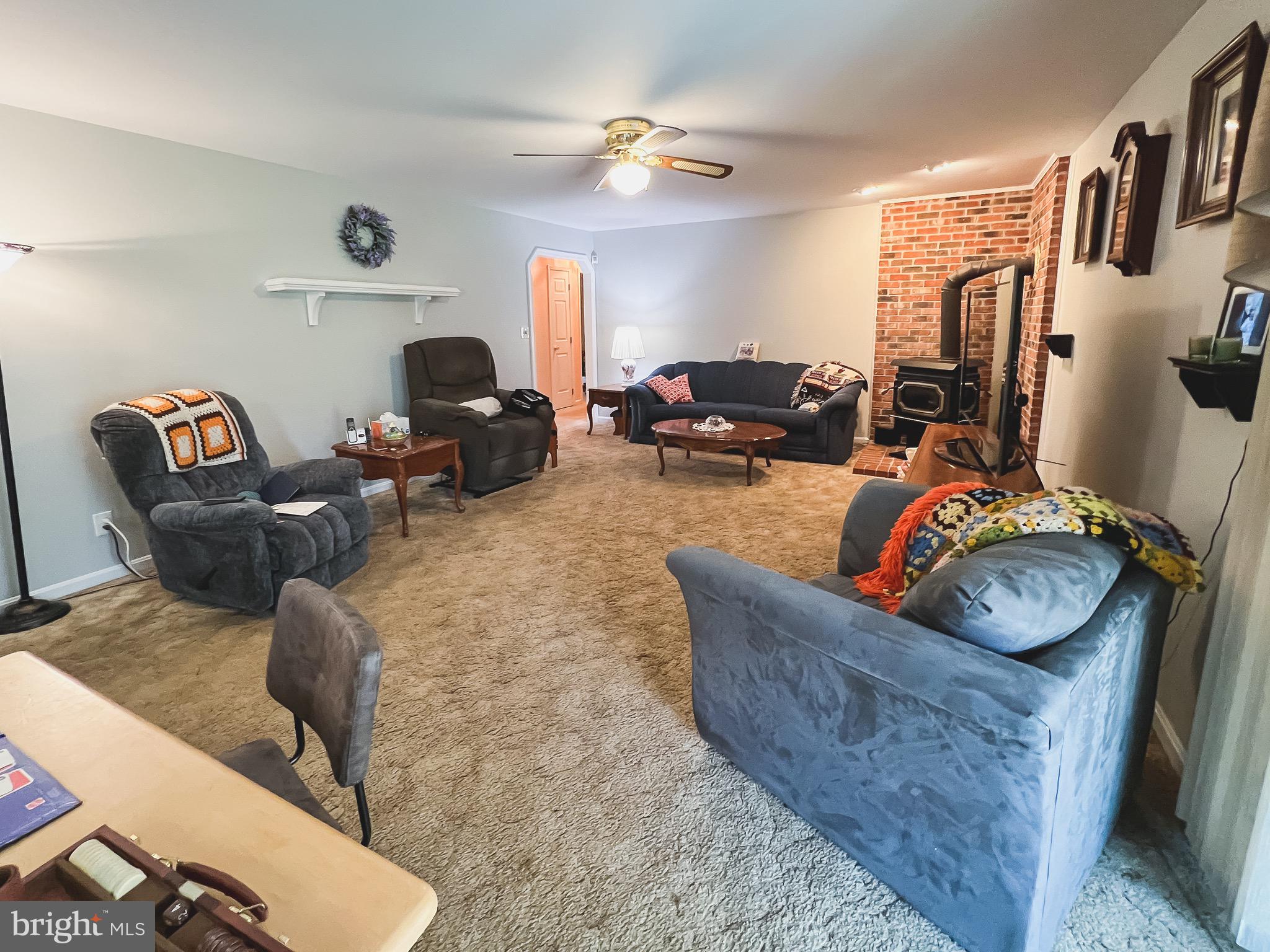 890 Carson Road Huntingtown, MD 20639 - Photo 13 of 64 a living room with furniture a fireplace and a flat screen tv