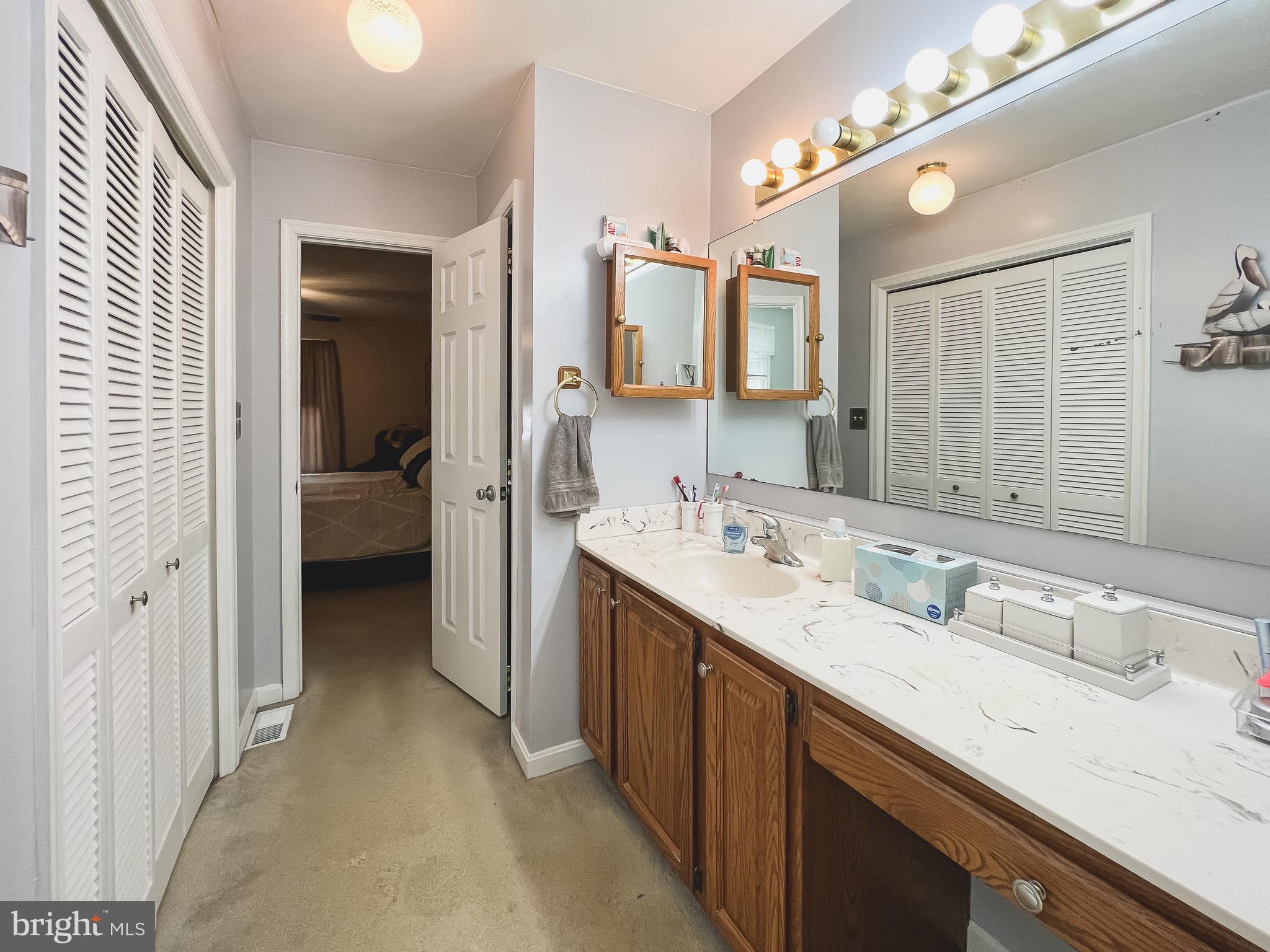 890 Carson Road Huntingtown, MD 20639 - Photo 24 of 64 a en suite bathroom with a double vanity sink and mirror