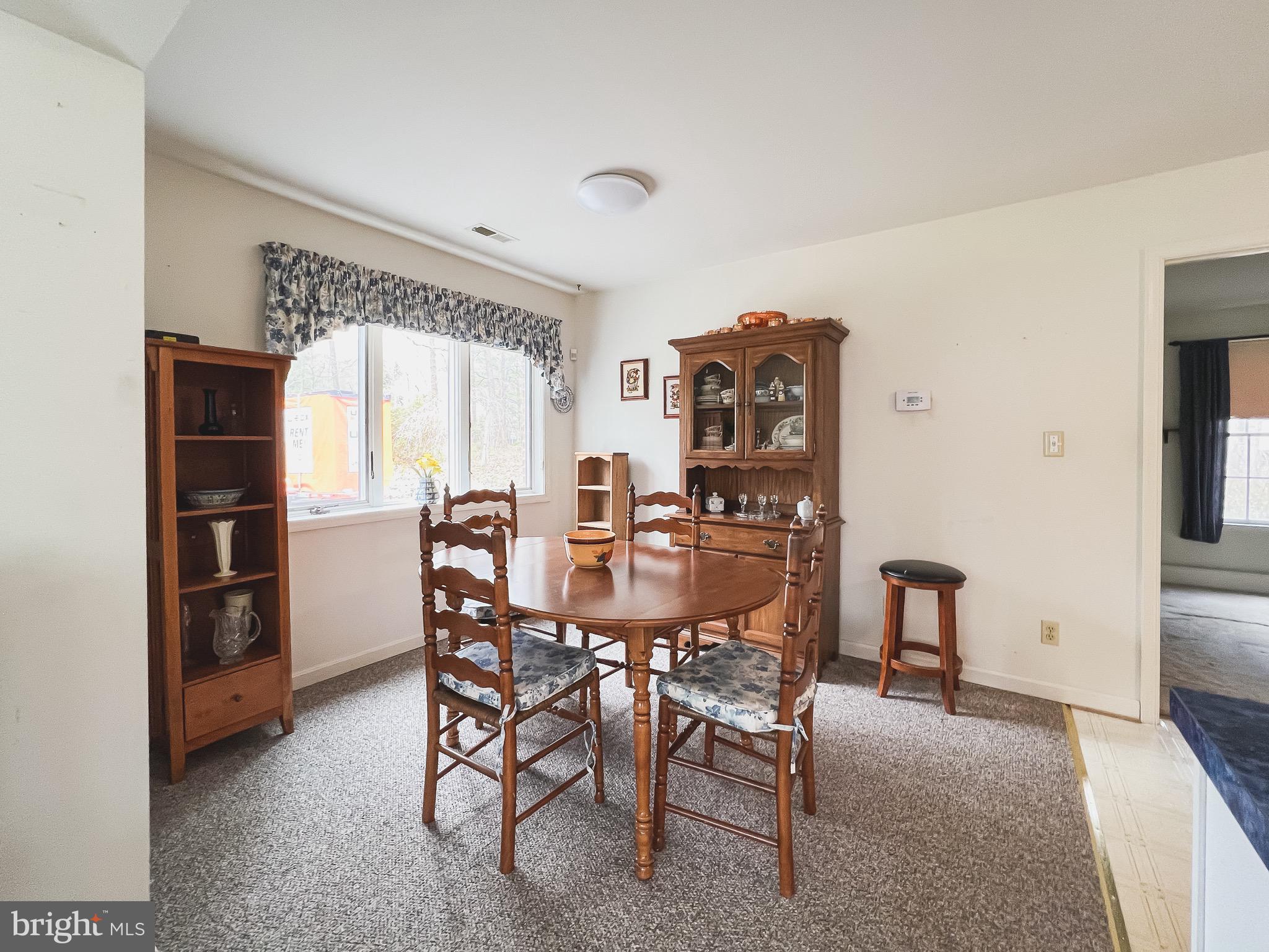 890 Carson Road Huntingtown, MD 20639 - Photo 48 of 64 a view of a dining room with furniture and window