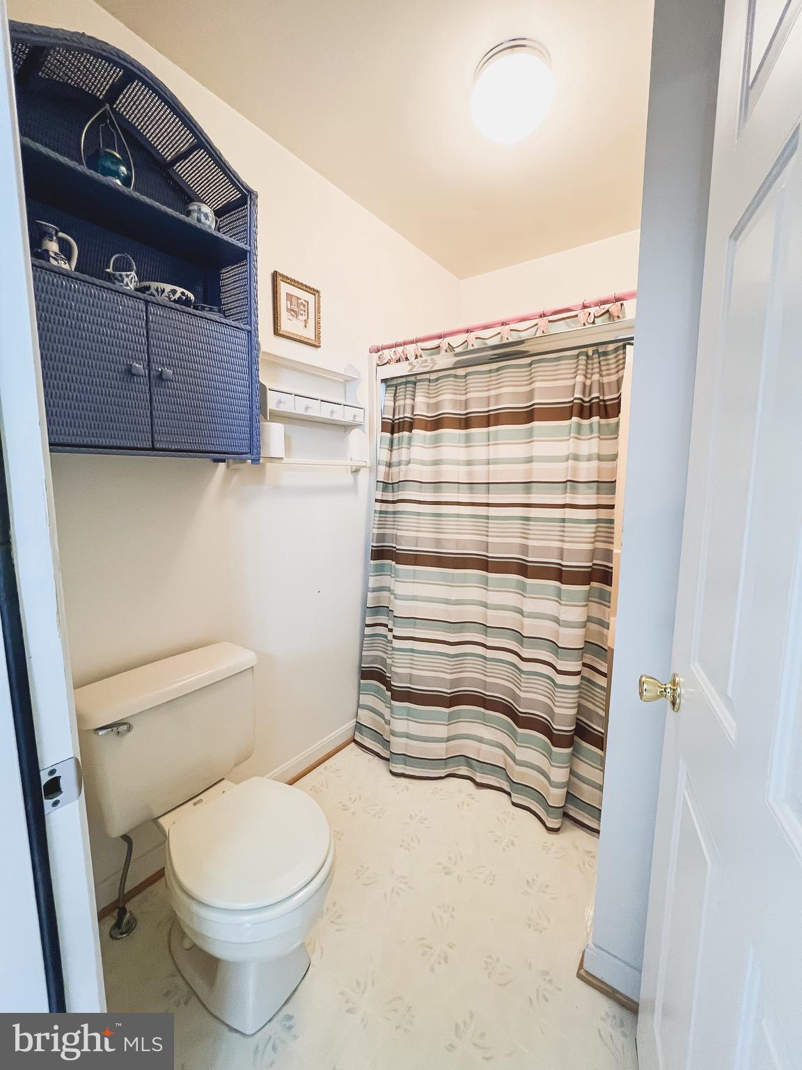 890 Carson Road Huntingtown, MD 20639 - Photo 51 of 64 a bathroom with a toilet and a shower
