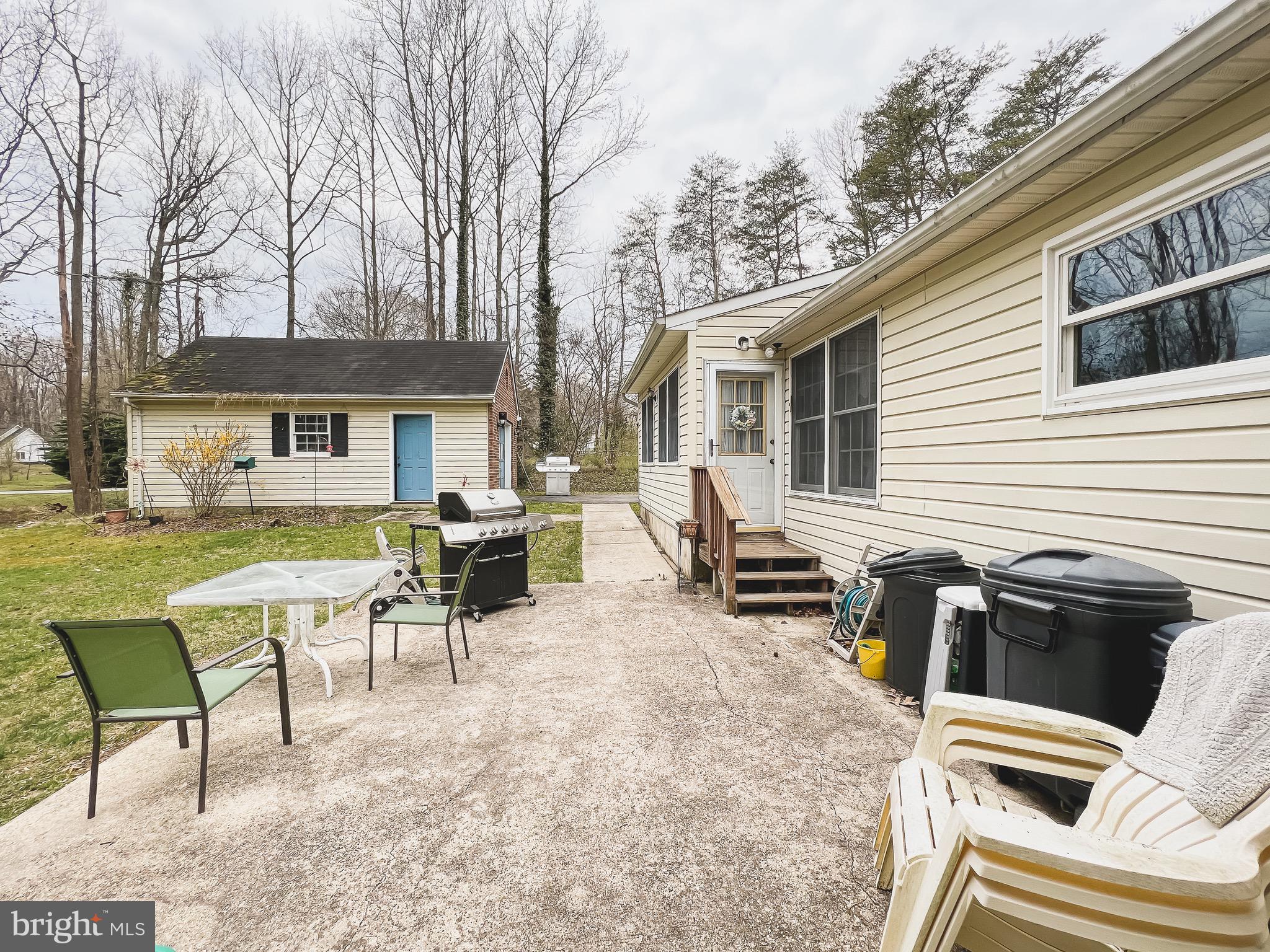 890 Carson Road Huntingtown, MD 20639 - Photo 52 of 64 a view of a patio with table and chairs and couches