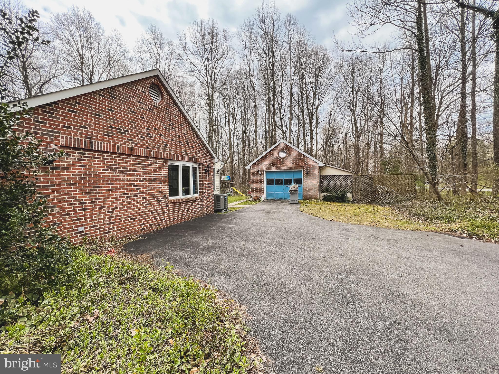 890 Carson Road Huntingtown, MD 20639 - Photo 60 of 64 a front view of a house with large trees