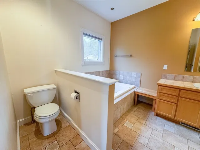 a bathroom with a sink a toilet and mirror