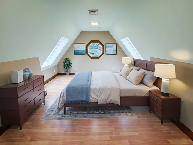 a bedroom with a bed and a chandelier