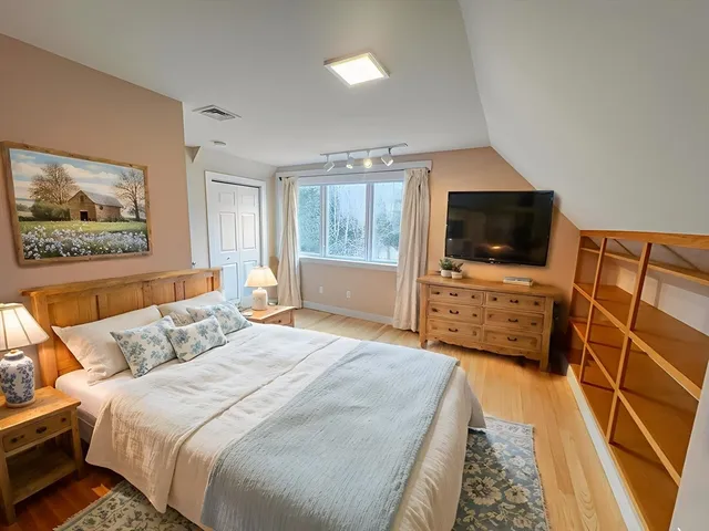 a bedroom with a bed and a flat screen tv