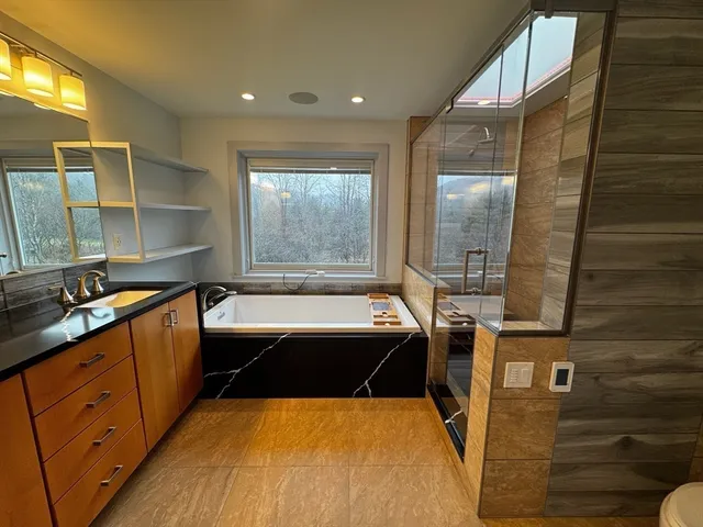 a large bathroom with a tub and sink