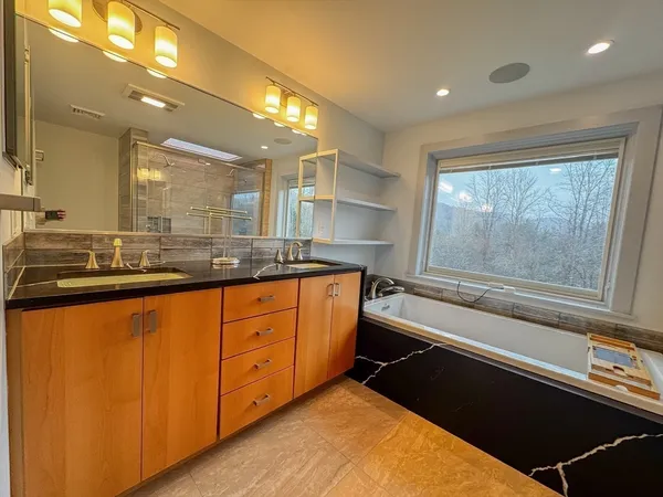 a bathroom with a granite countertop sink mirror and double