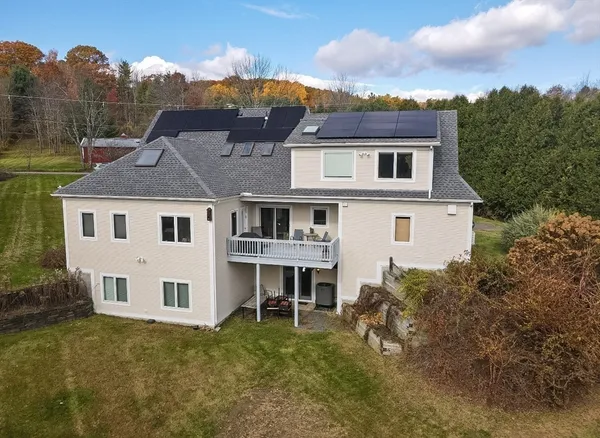 a aerial view of a house next to a yard