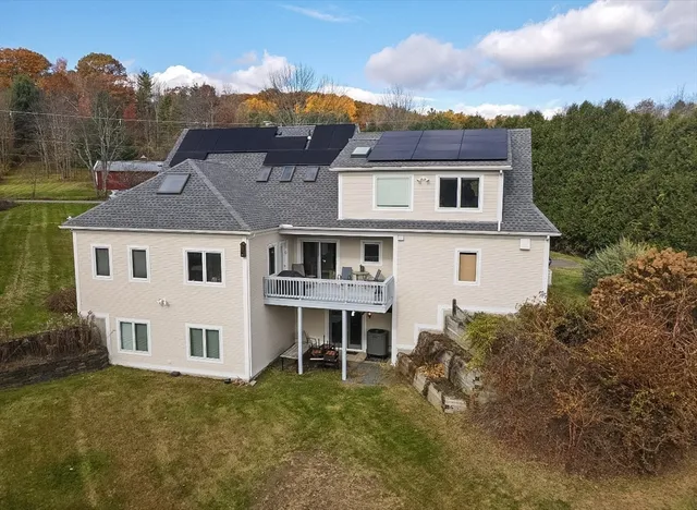 a aerial view of a house next to a yard